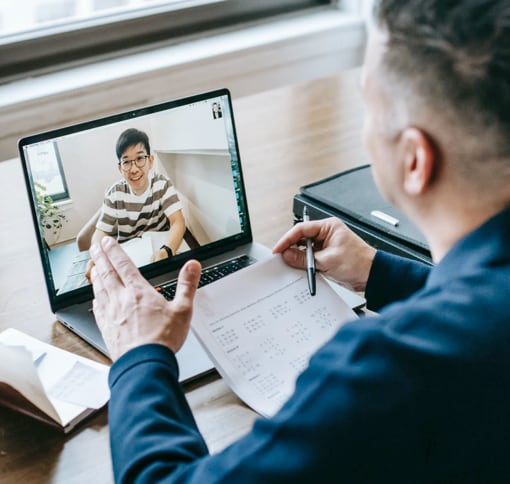 Two people in a video conference meeting.